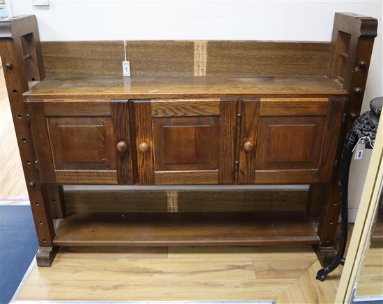 A small oak cheese press bookcase , the cupboard enclosed by three doors W.150cm